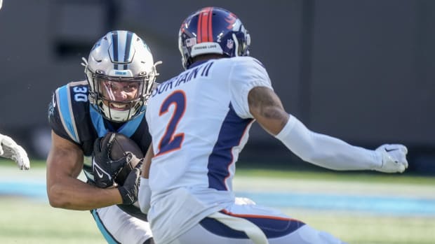 Carolina Panthers running back Chuba Hubbard (30)j tries to get past Denver Broncos cornerback Pat Surtain II (2) during the first quarter at Bank of America Stadium.